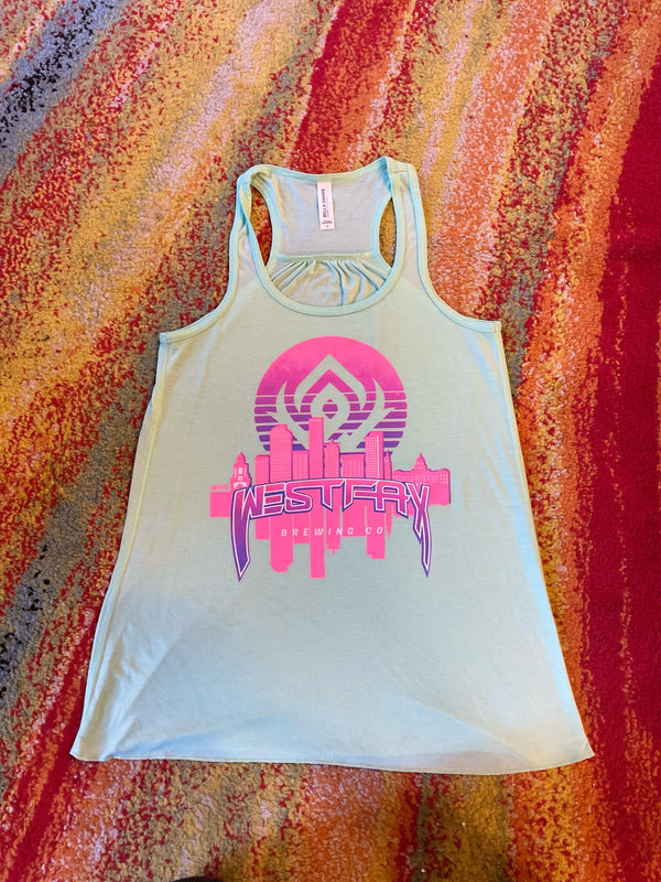 Light blue tank top with pink and purple graphic design on a colorful abstract background